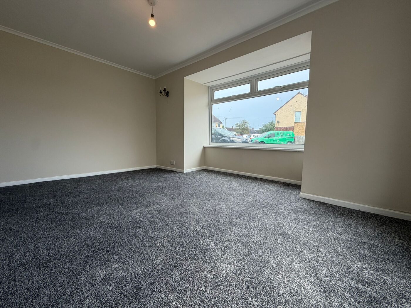 Refurbished living room with bay window and new carpet